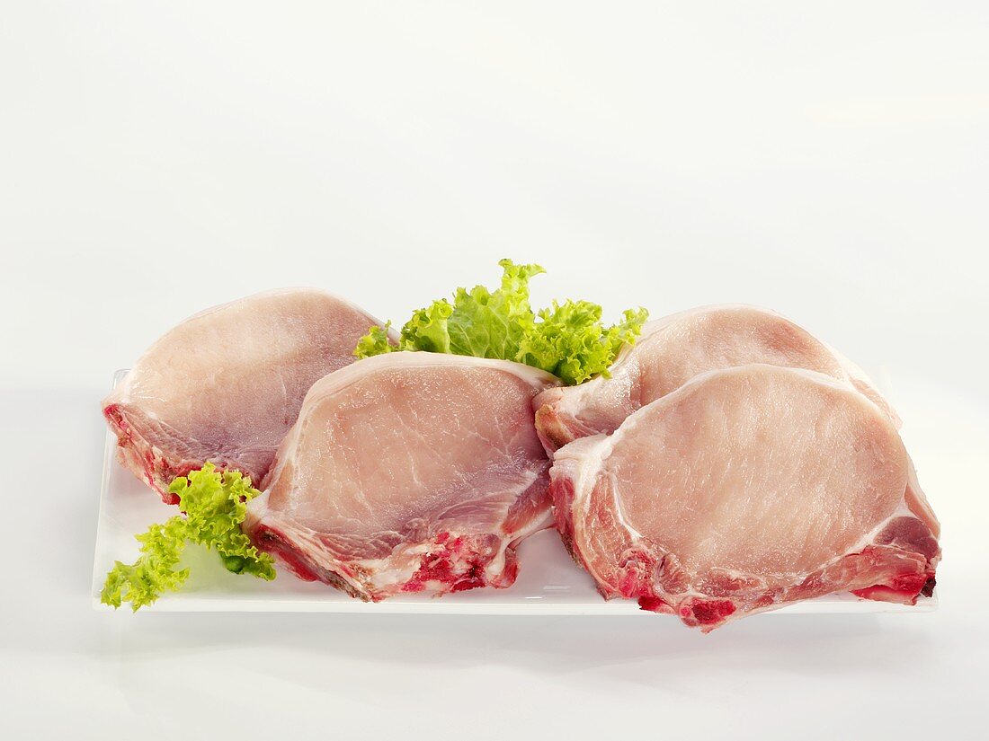 Four pork chops on a serving platter