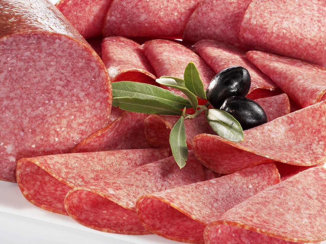 Sliced salami and olives