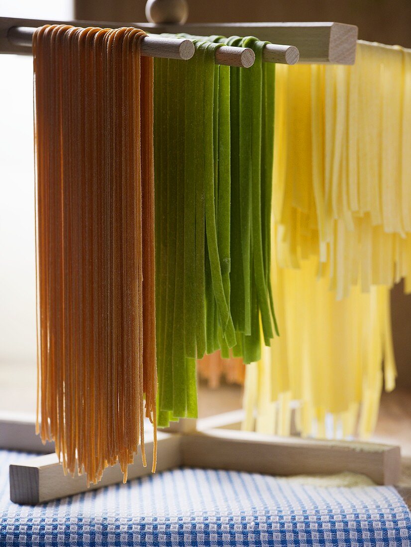 Coloured pasta hanging up to dry