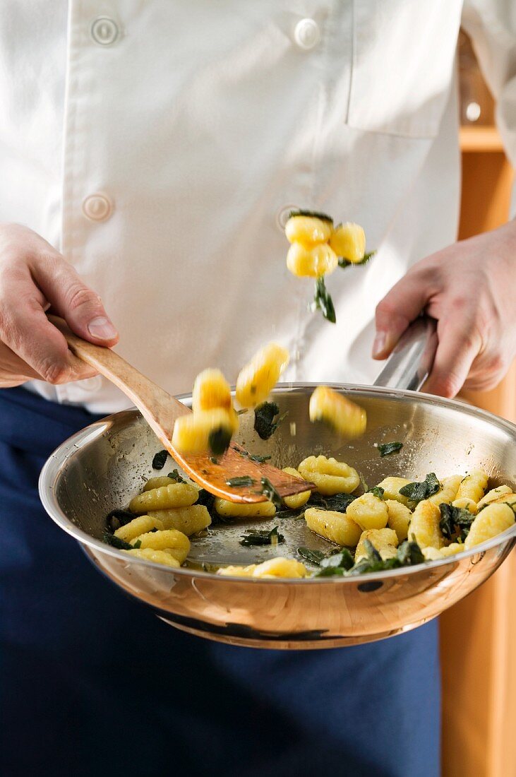 Tossing sage gnocchi in a frying pan