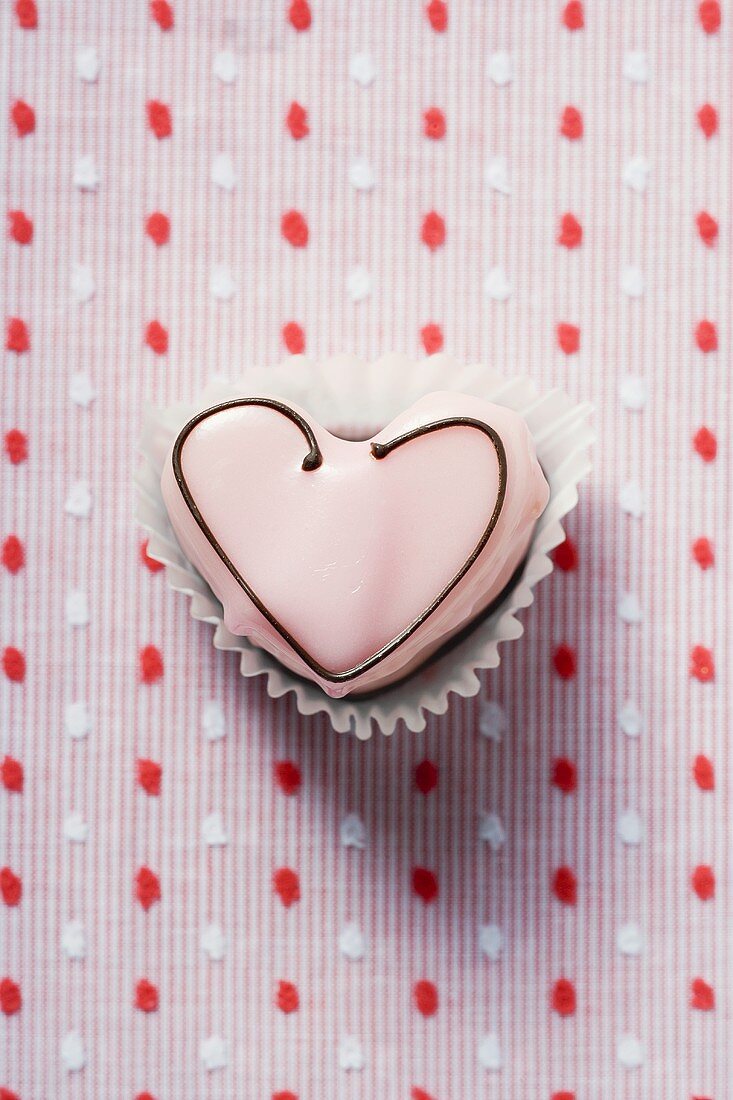Heart-shaped sweet with pink icing