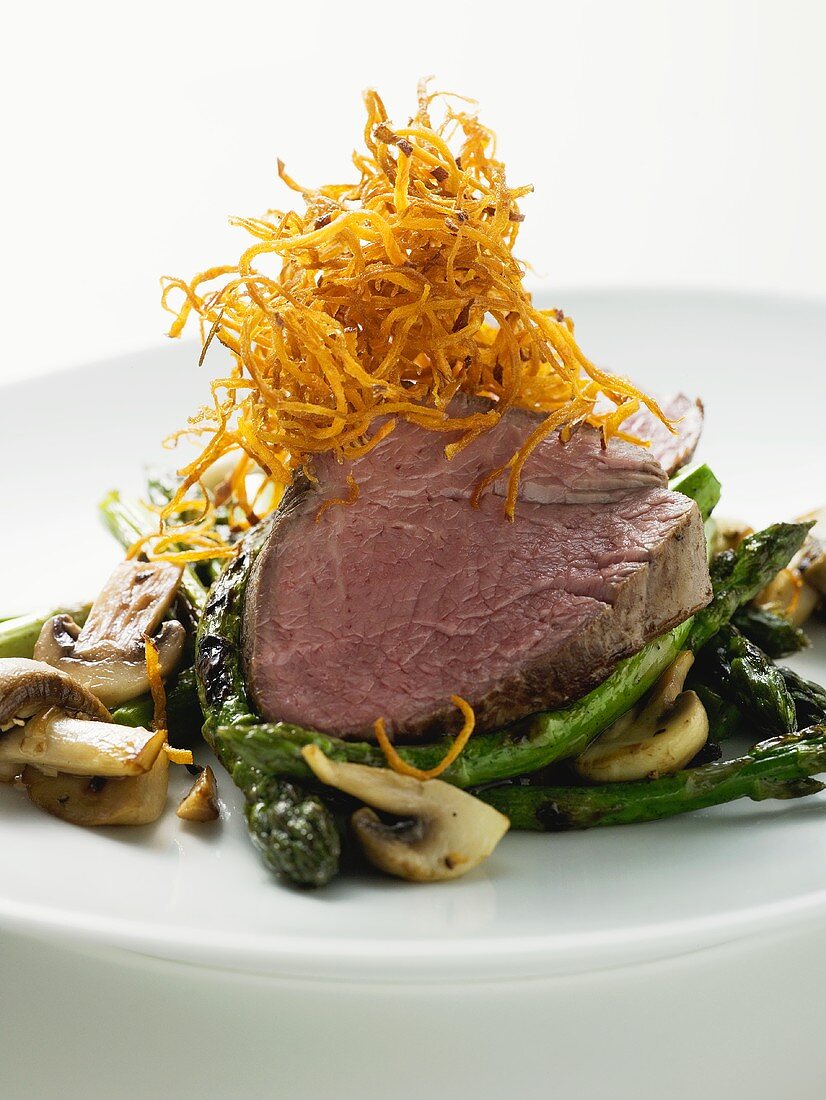 Beef fillet on green asparagus