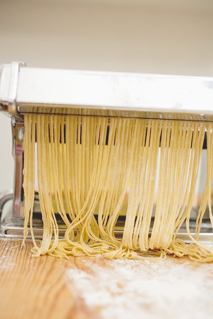 Home-made tagliatelle in pasta maker