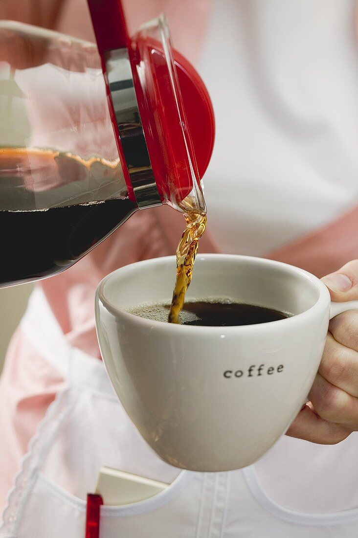 Pouring coffee into a cup