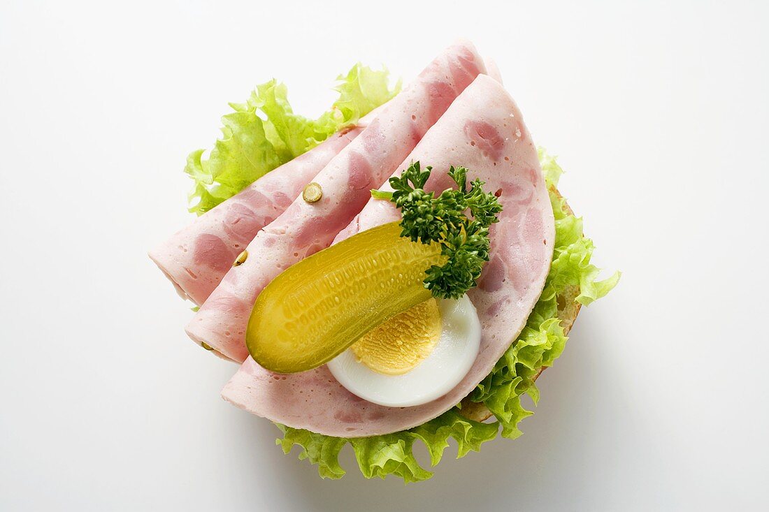 Bierschinken (ham sausage), gherkin and egg on half a roll
