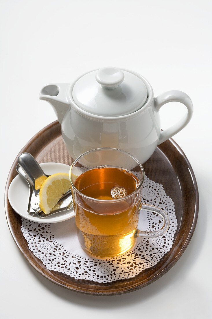 A serving of black tea with lemon