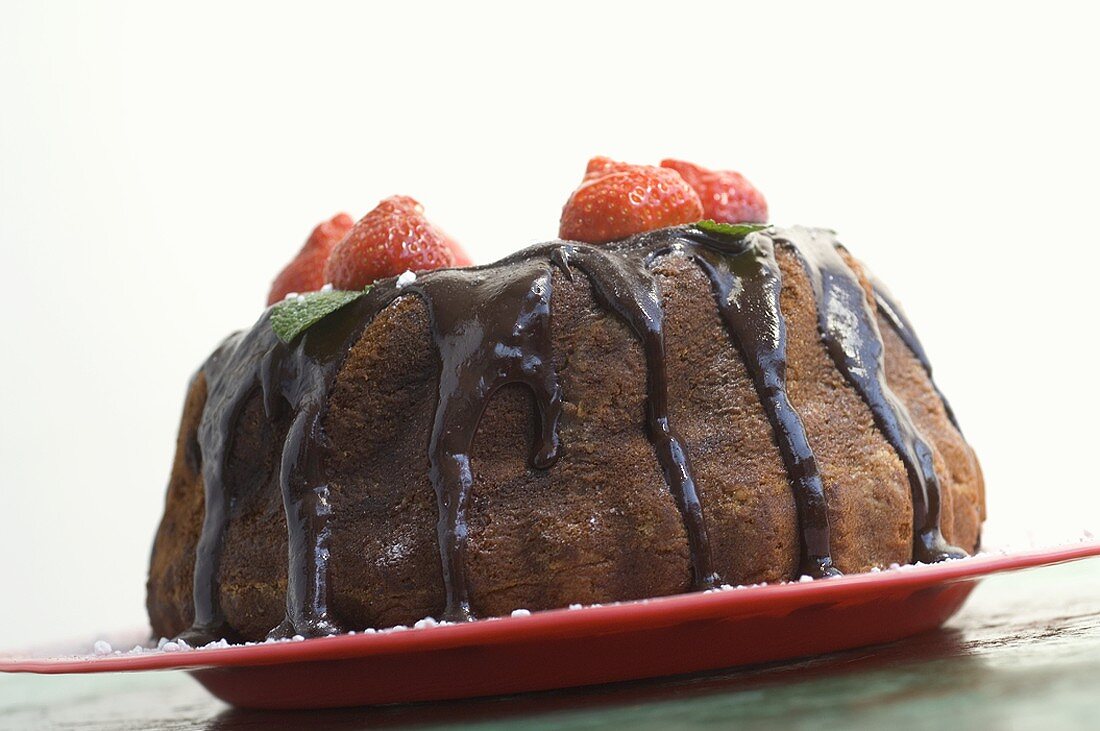 Ring cake with chocolate sauce and strawberries