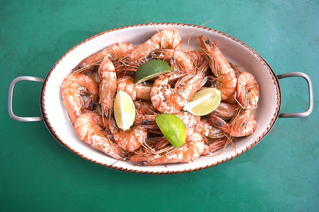 Cooked prawns with sea salt and lime wedges