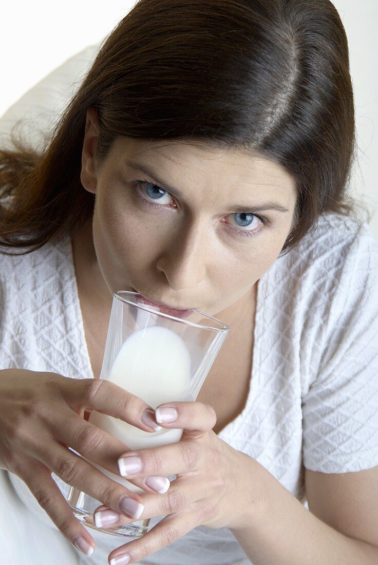 Woman drinking a glass of milk