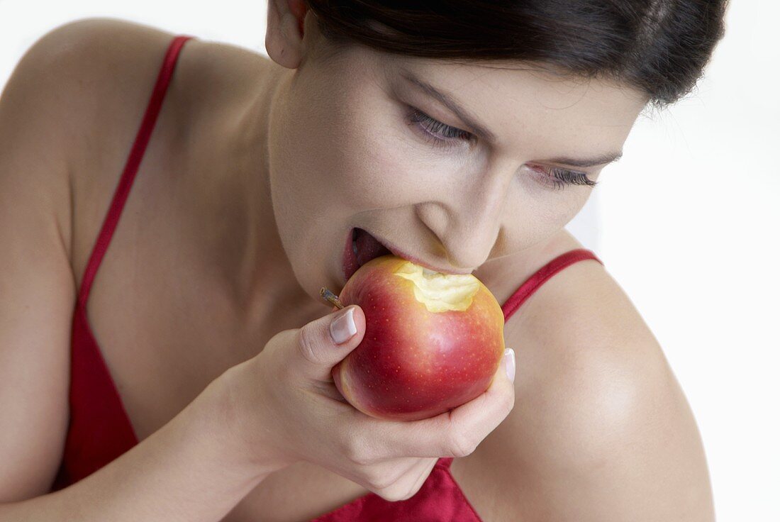 Woman biting into an apple