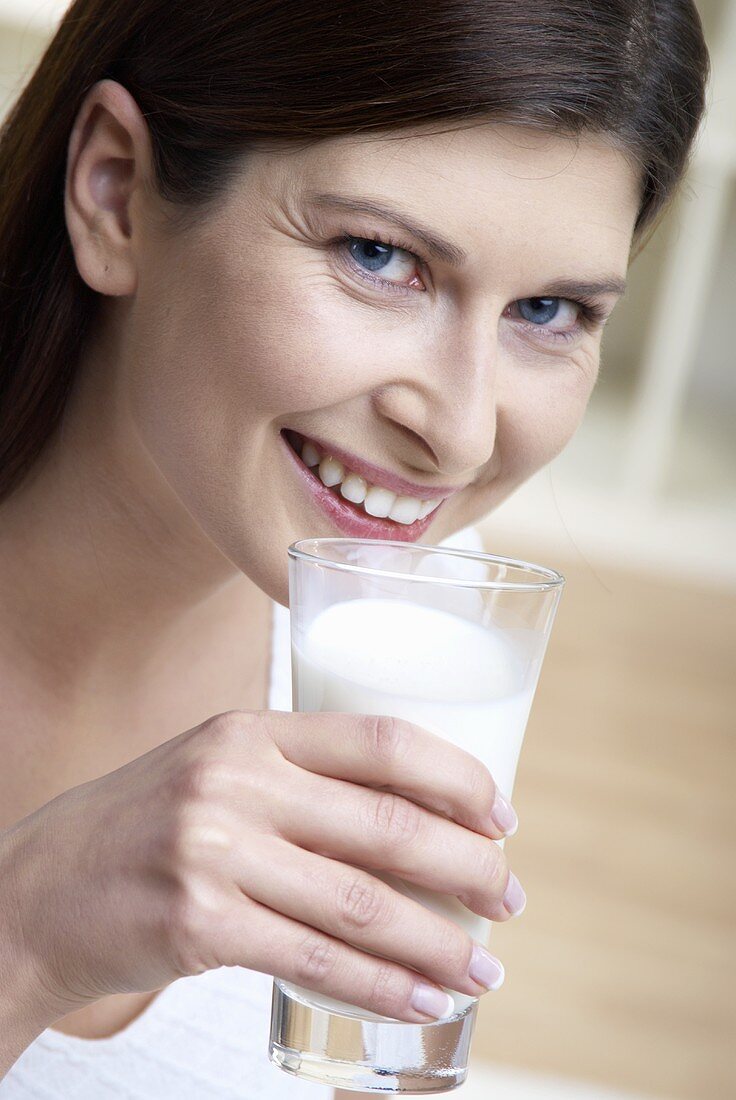 Woman holding a glass of milk in her hand
