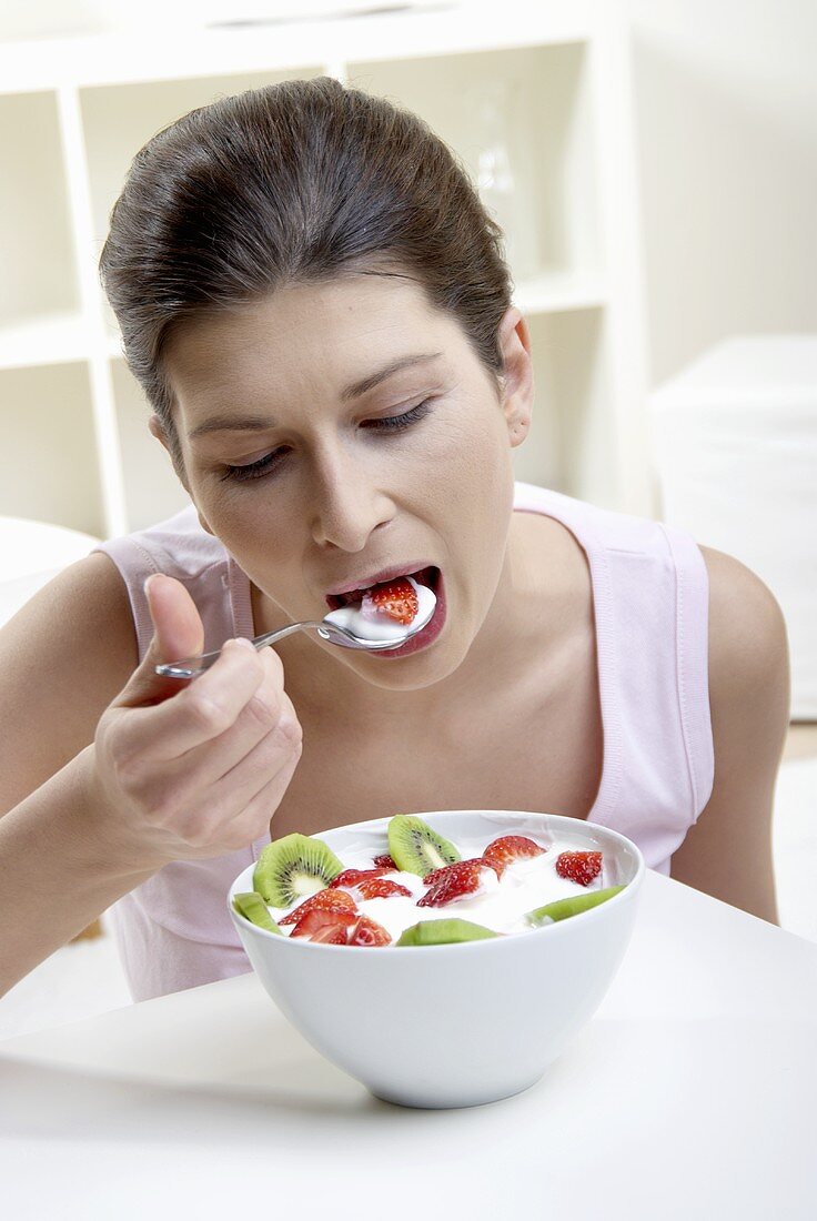 Woman eating fruit yoghurt