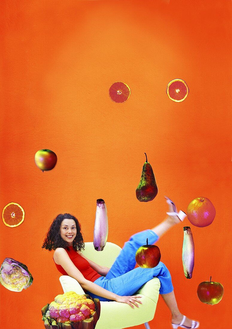 Woman sitting in chair surrounded by flying fruit & vegetables