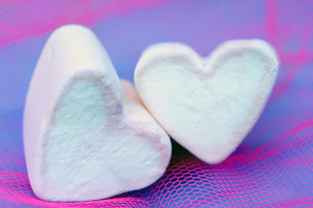Two pink and white marshmallow hearts