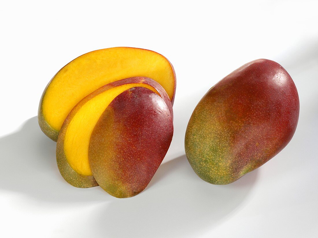 Whole and sliced mango