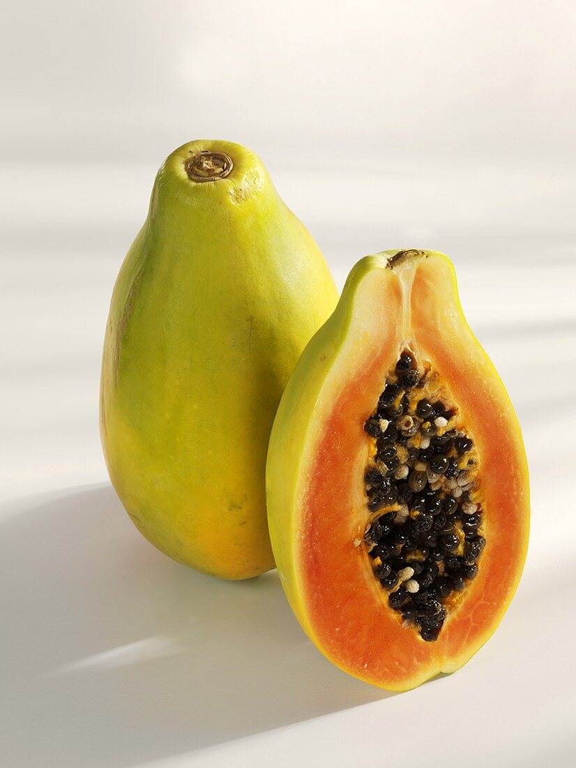 Whole and half papaya, standing