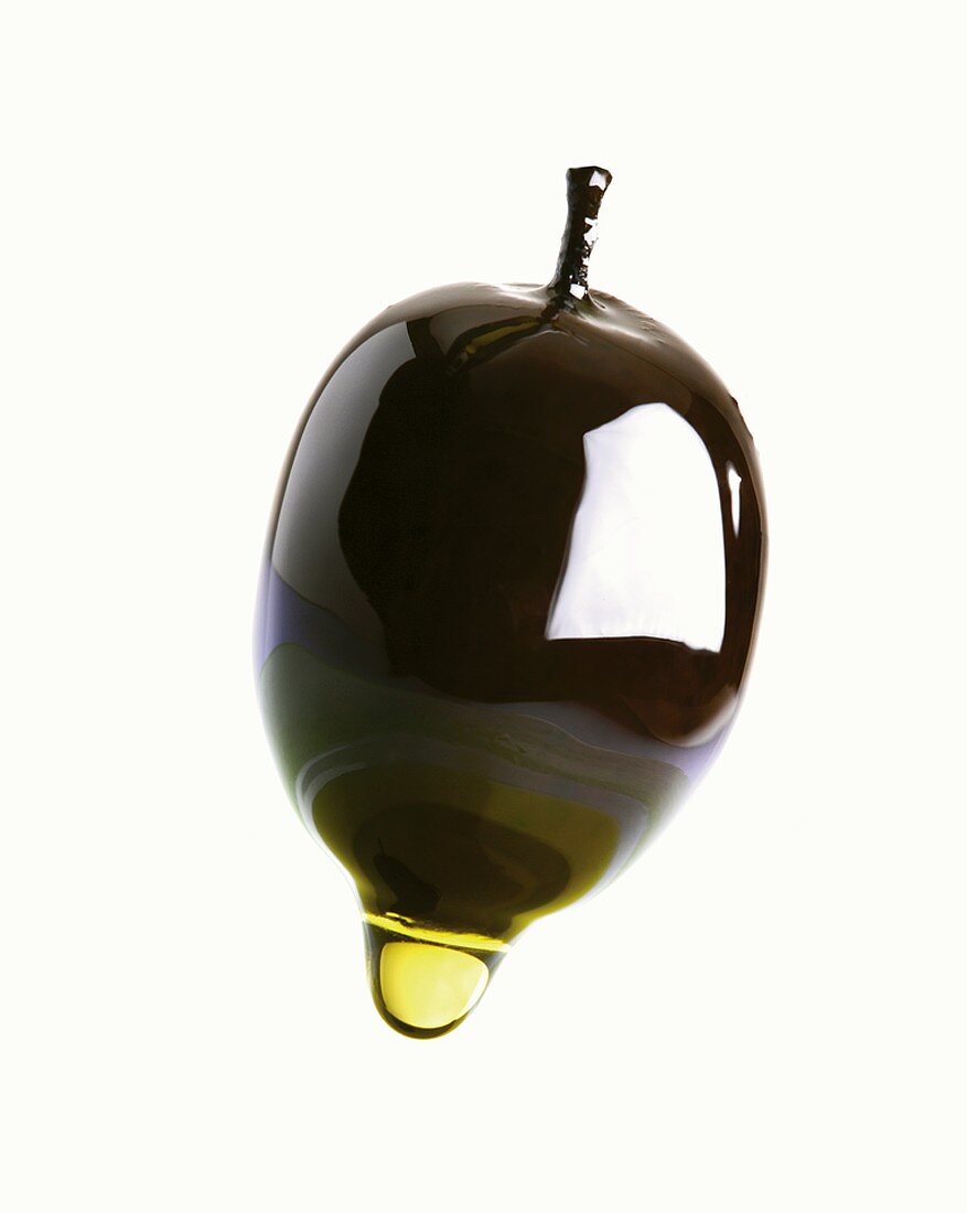 Olive oil dripping from an olive
