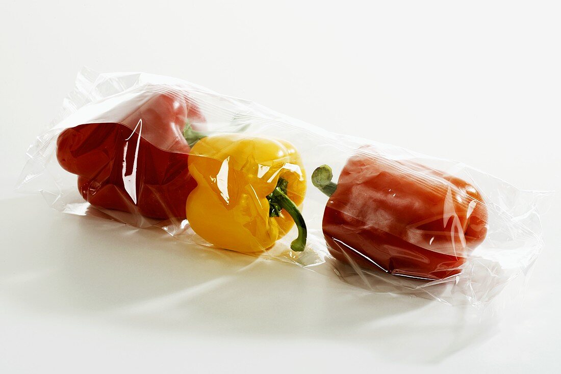 Three peppers in plastic packaging