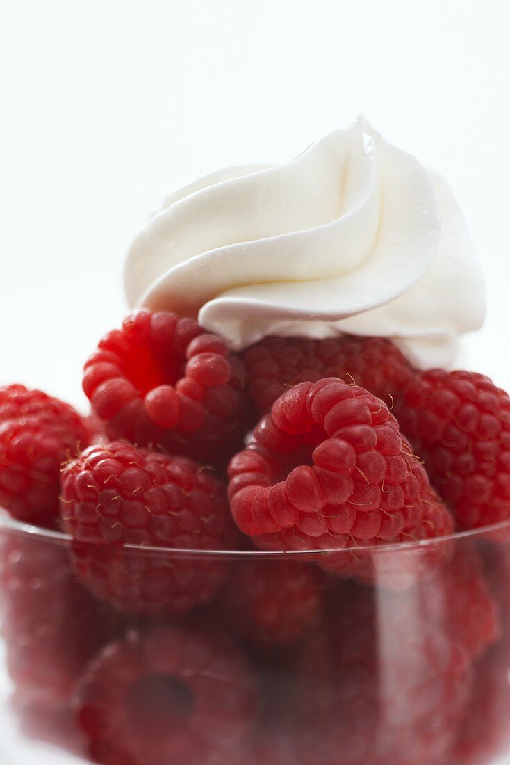 Raspberries in a glass with cream