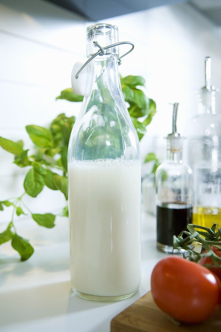 A bottle of milk beside other ingredients