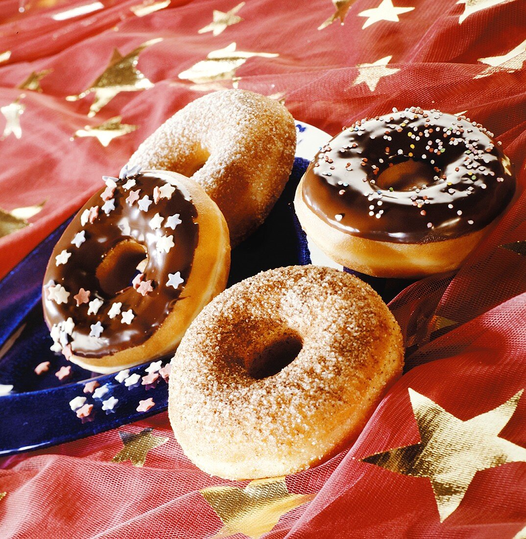 Four doughnuts on a star-patterned cloth