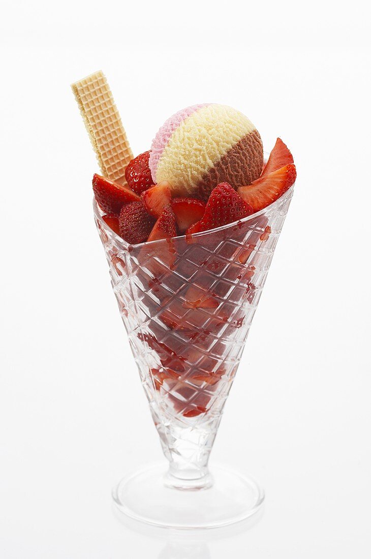 Strawberries and Neapolitan ice cream in sundae glass