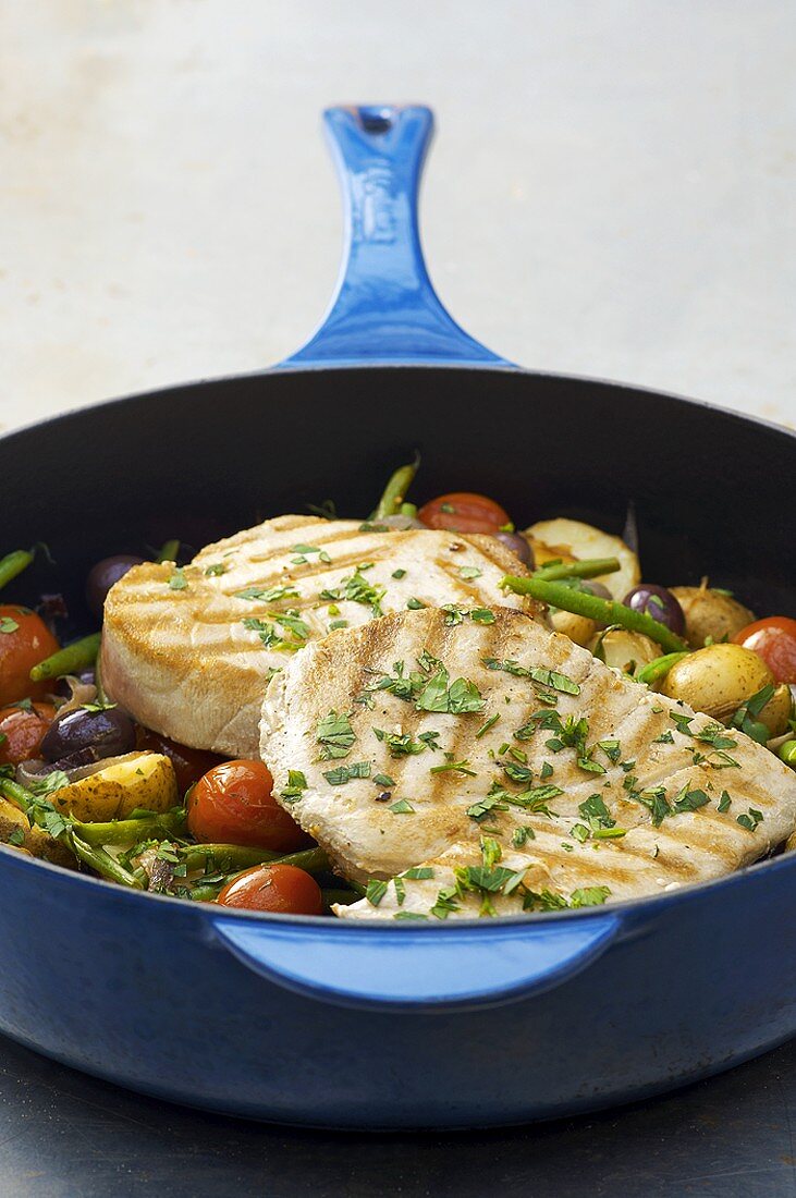 Braised tuna steaks with vegetables