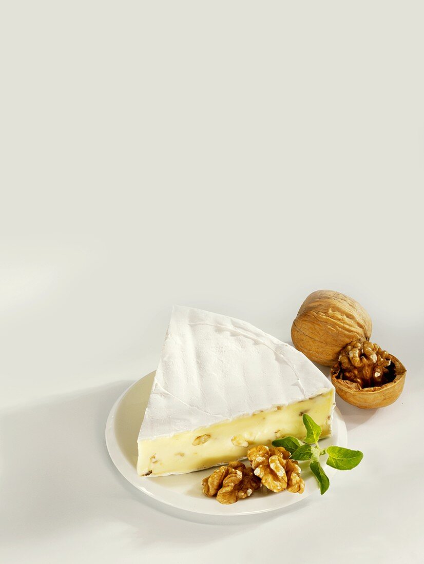 A piece of Brie with walnuts