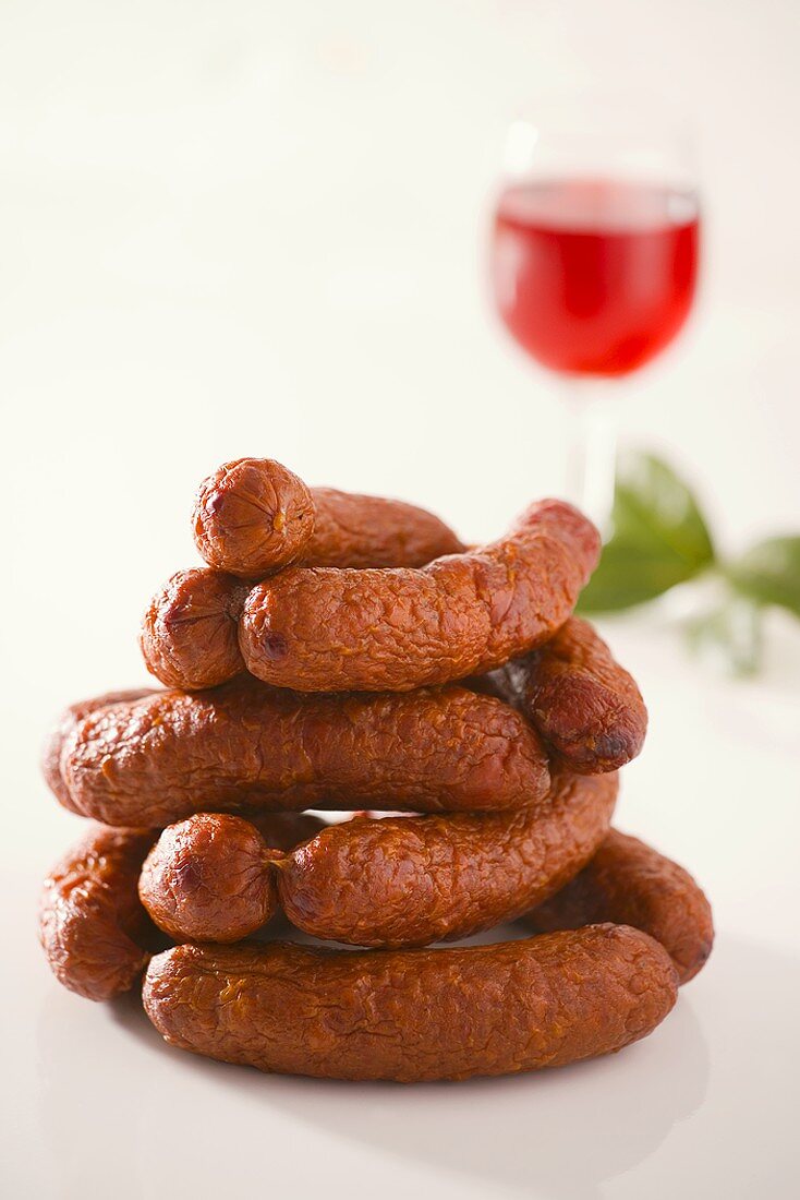 Smoked sausages with wine in background