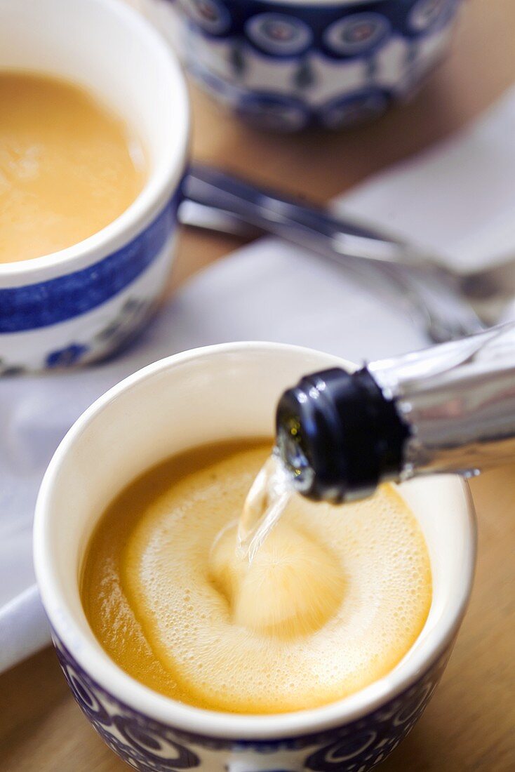 Pouring champagne into champagne carrot cappuccino