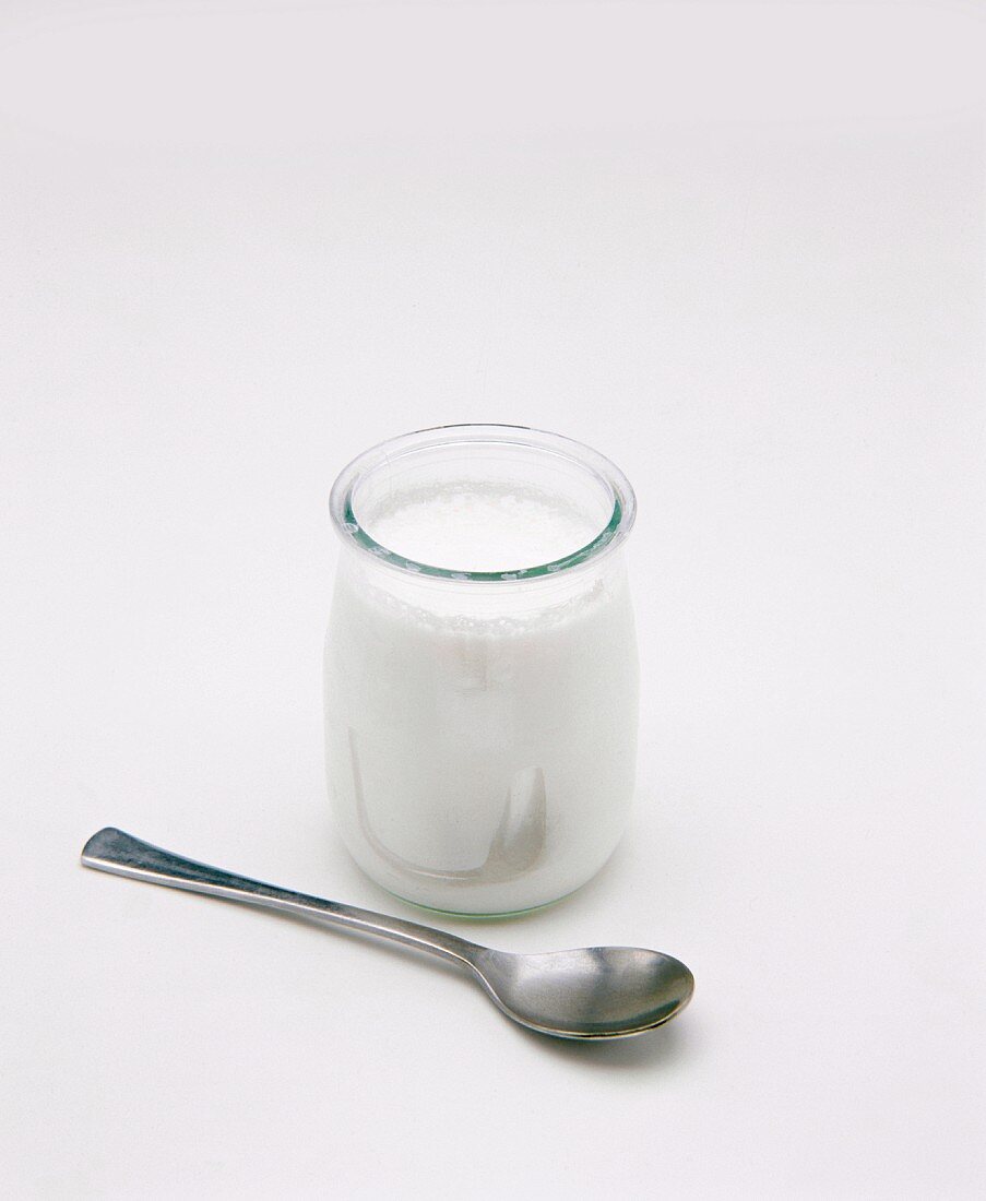 Jar of yoghurt and spoon