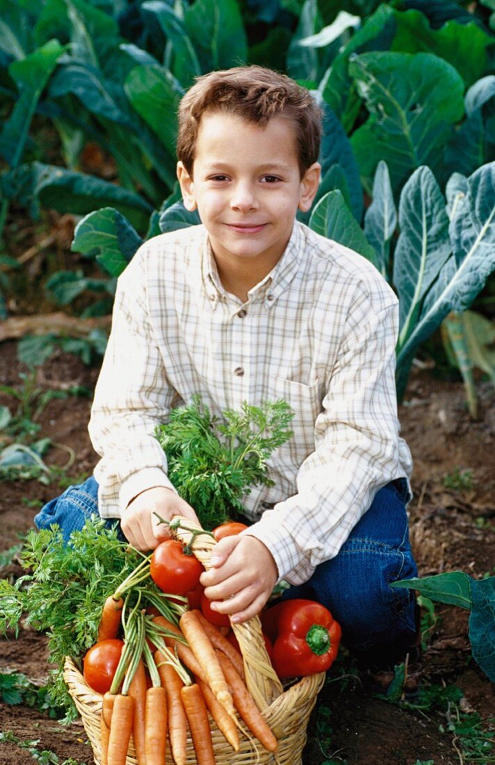 A boy with a basket of vegetables (outdoors)