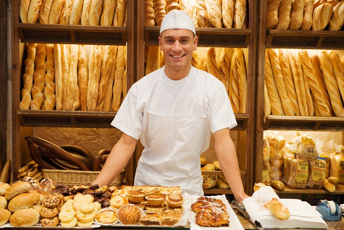 Baker behind bakery sales counter