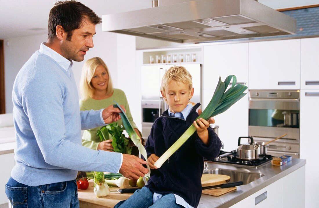 Family in kitchen preparing vegetables