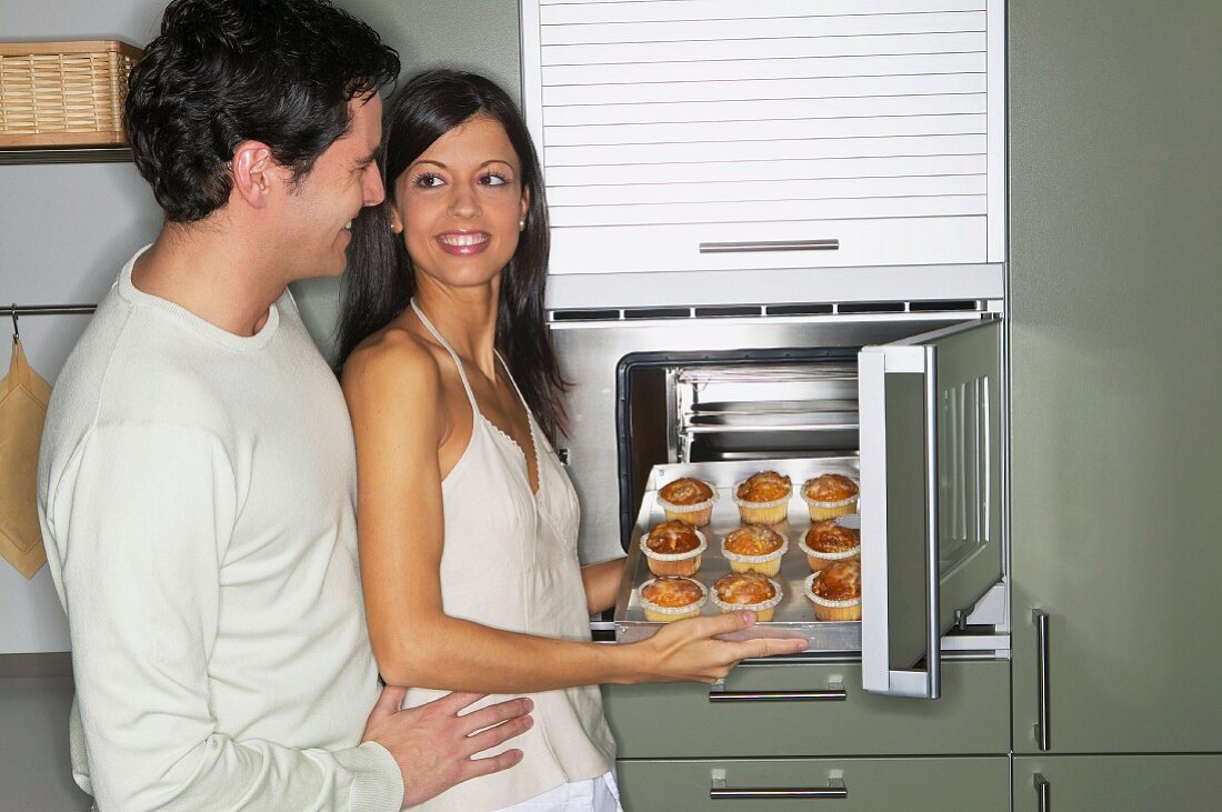 Couple baking muffins