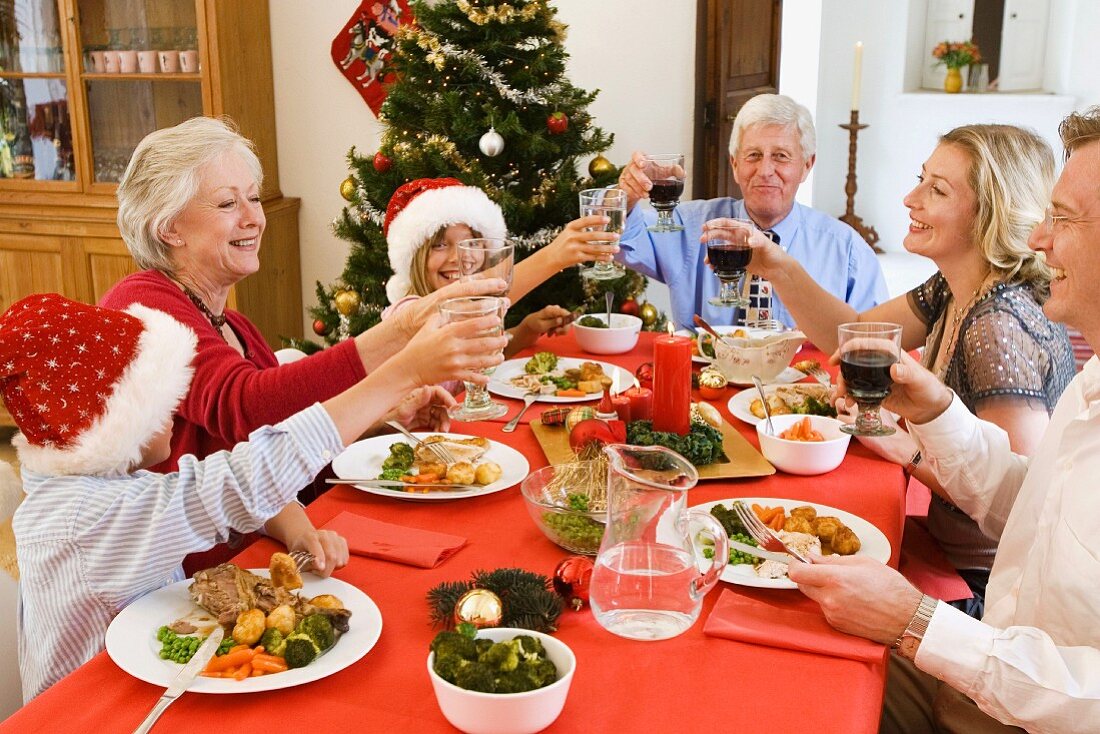 Family toasting each other over Christmas dinner