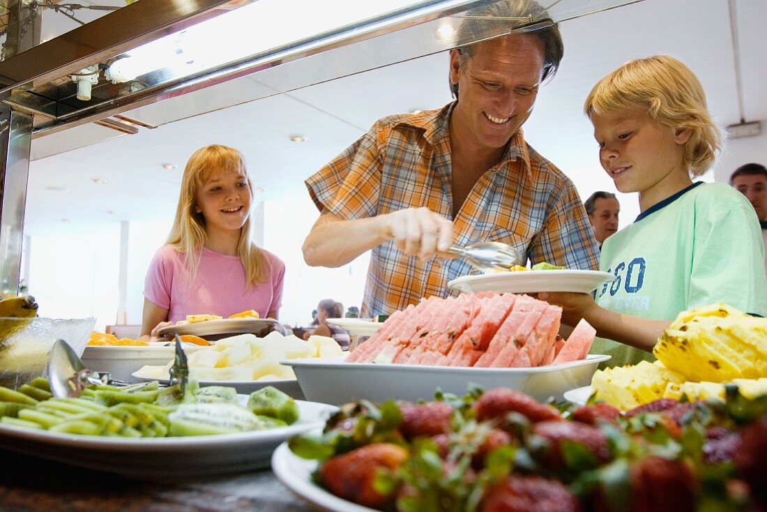 Father with children at buffet on holiday
