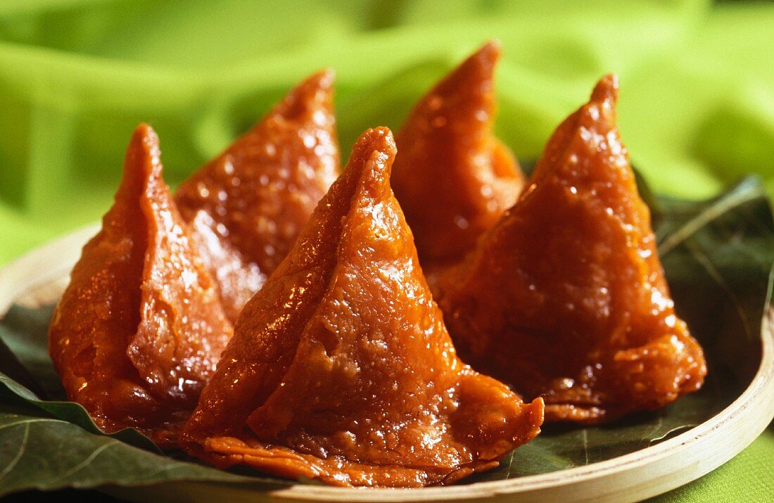 Deep-fried samosas in sugar (sweet snack, India)