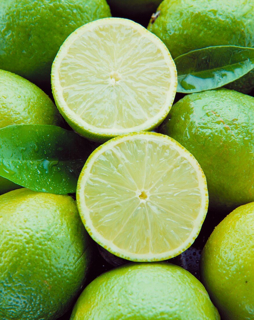 Two lime halves in a bed of limes