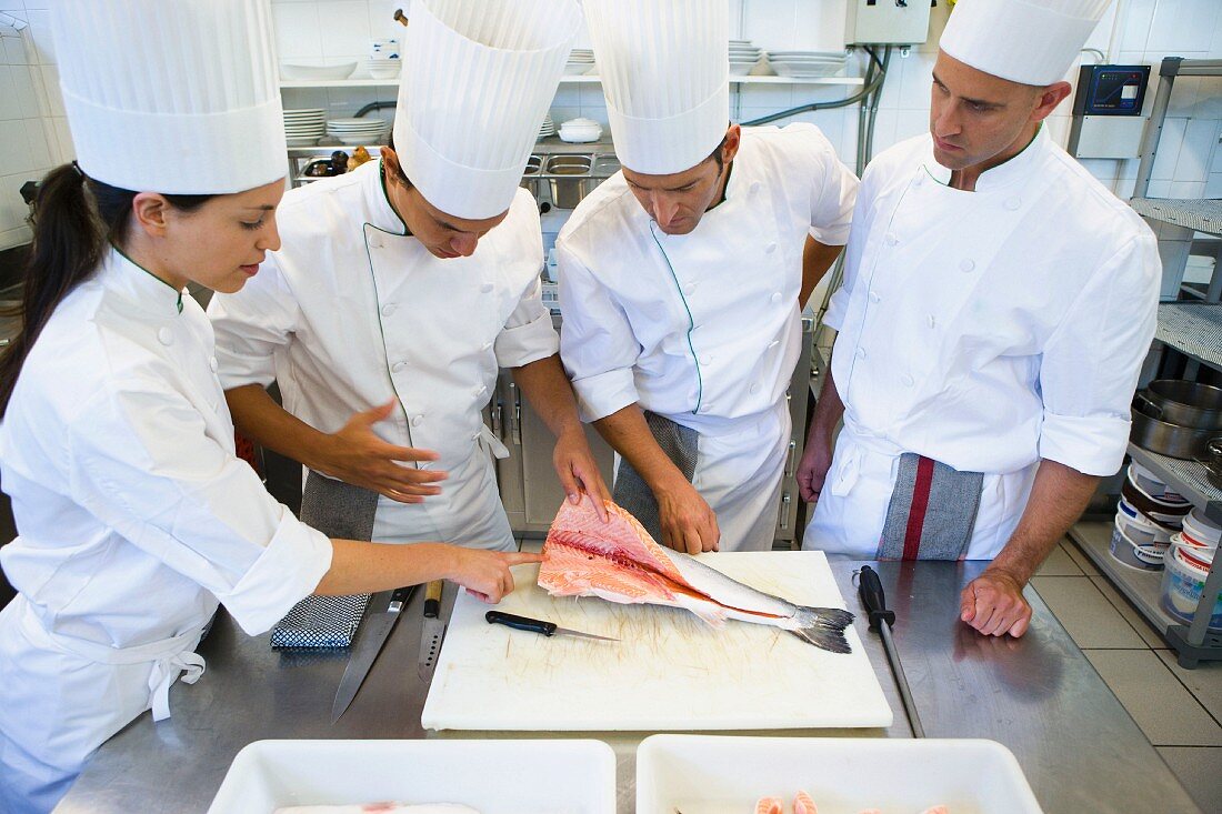 A chef filleting salmon