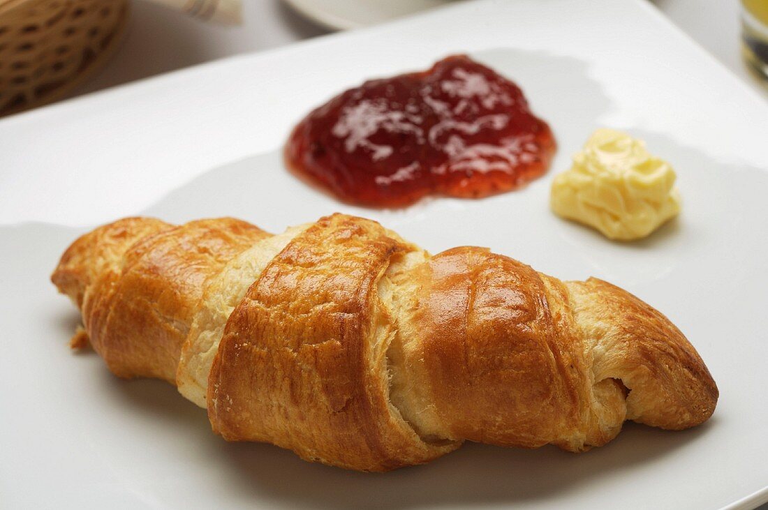 Croissant with jam and butter
