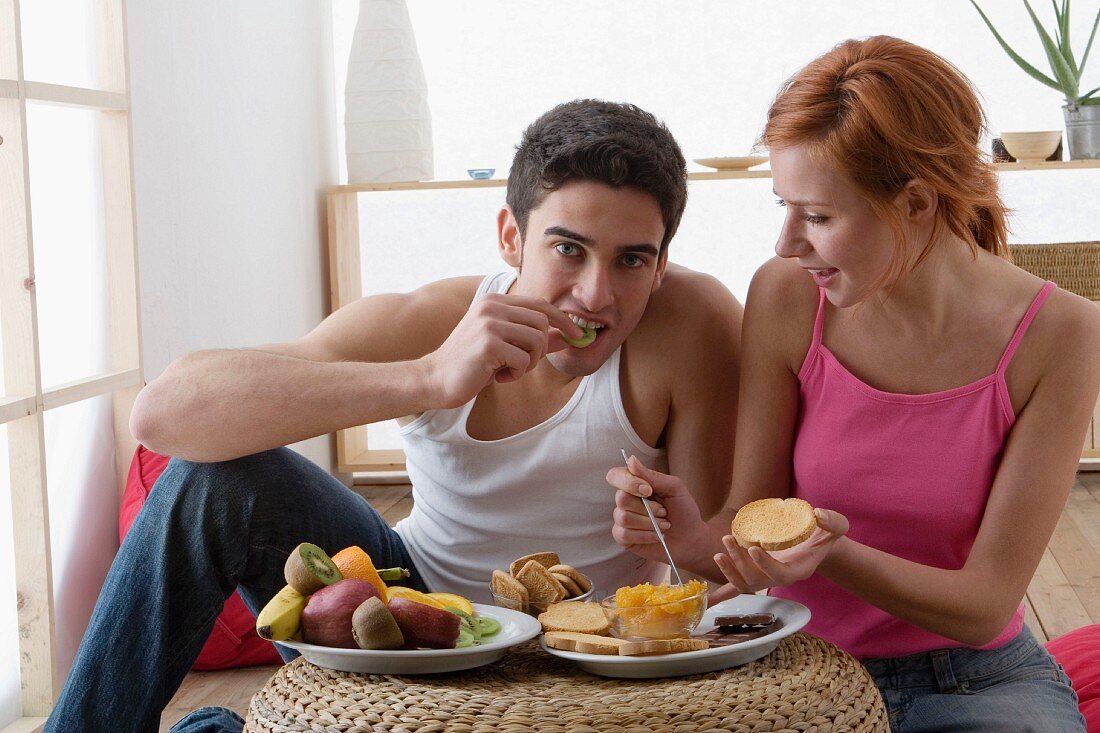 Couple eating fruit and rusks