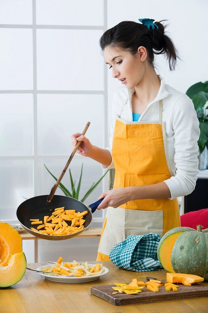 Woman frying pumpkin