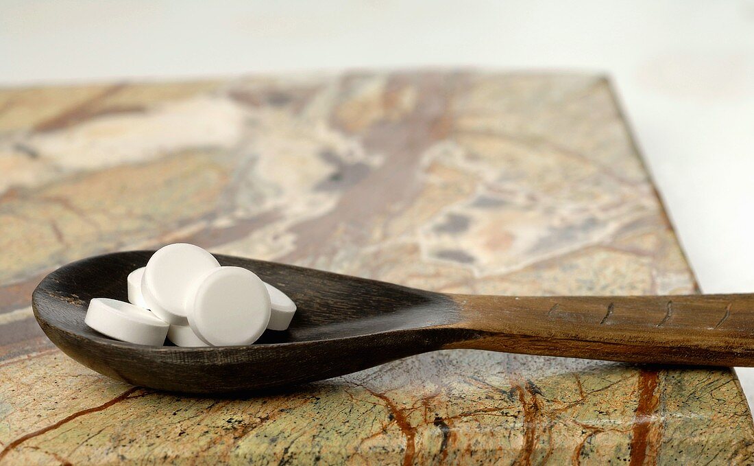 Schüssler Salts on wooden spoon