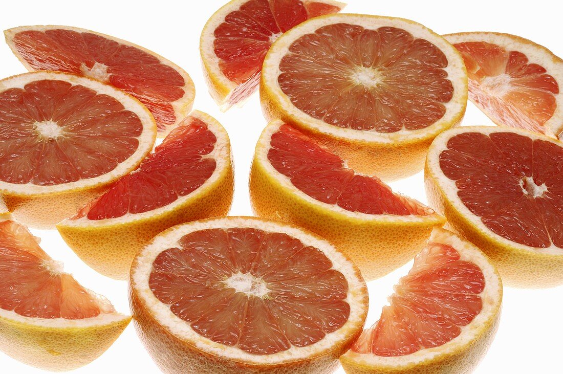 Pink grapefruits, halves and wedges