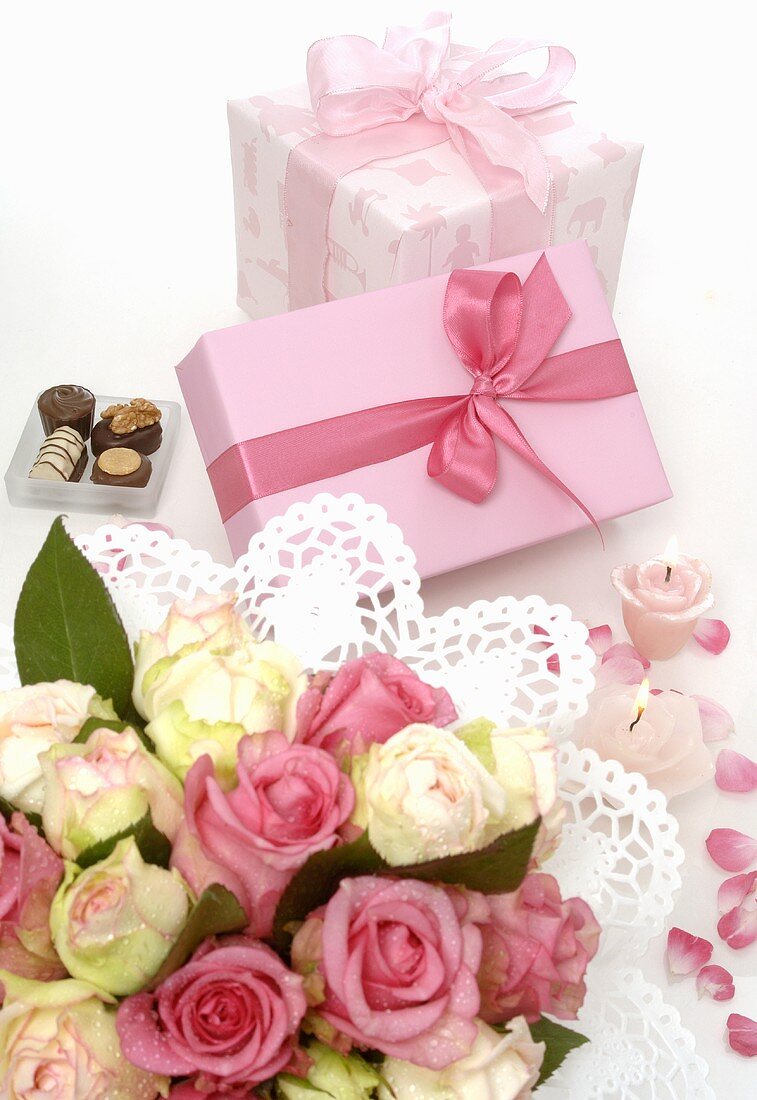 Two gifts, bouquet of flowers and chocolates