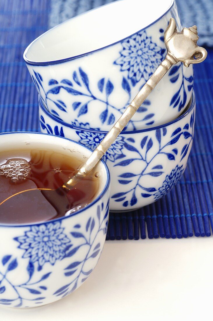 Tea in blue and white bowl with spoon (Asia)