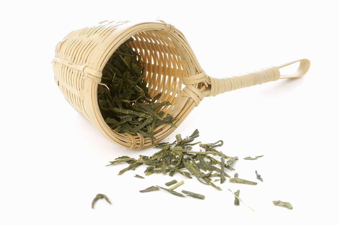 Green tea in bamboo tea strainer