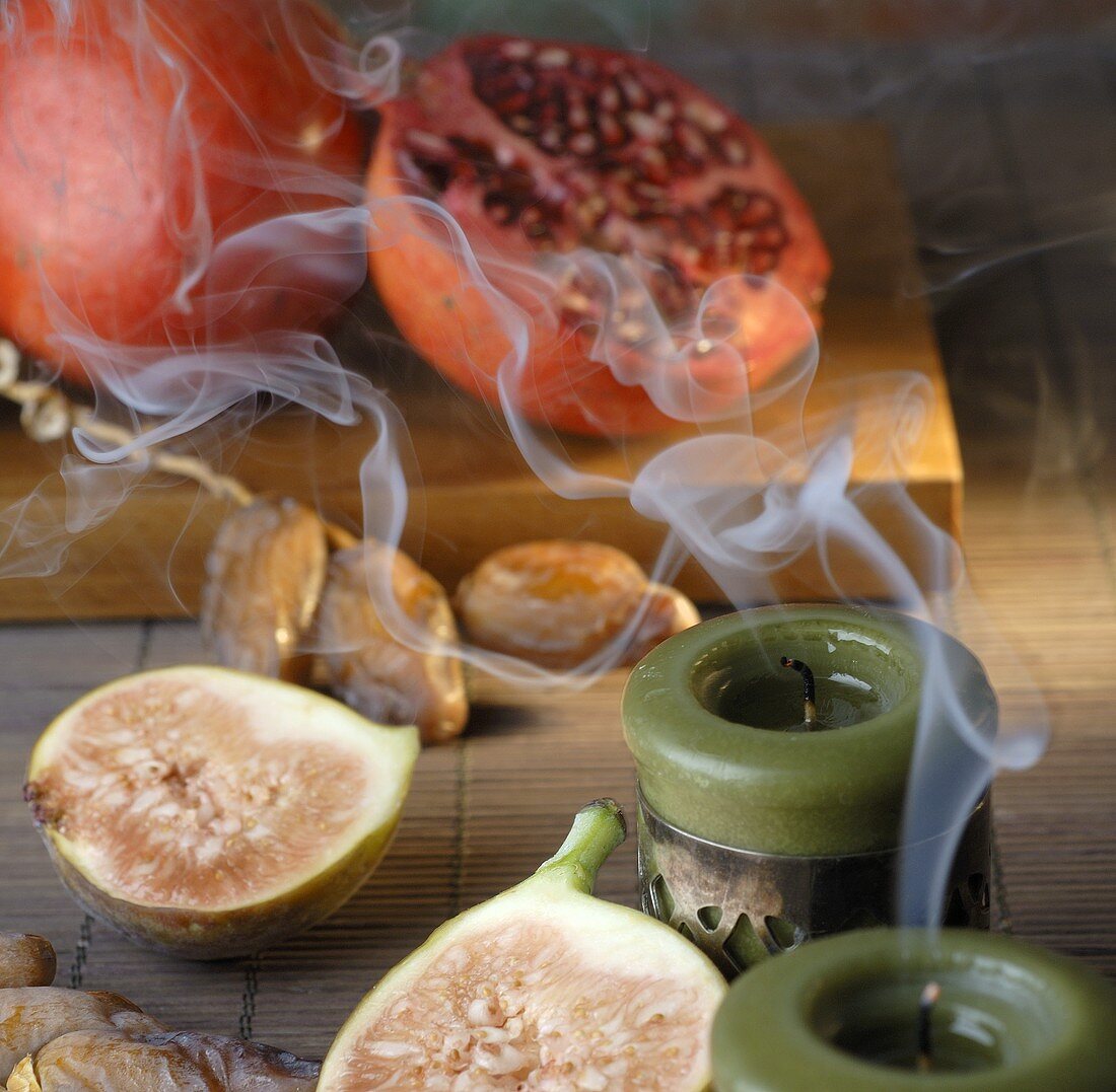 Pomegranates, dates and figs, smoking candles