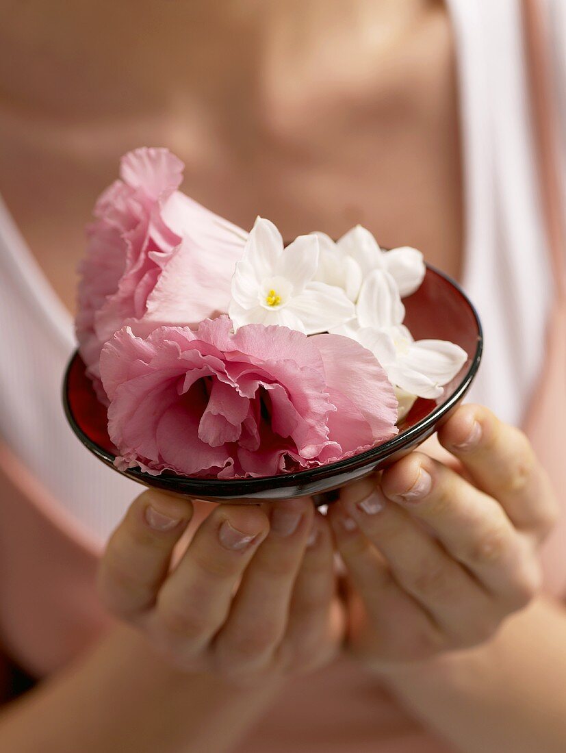 Woman with a small dish of flowers